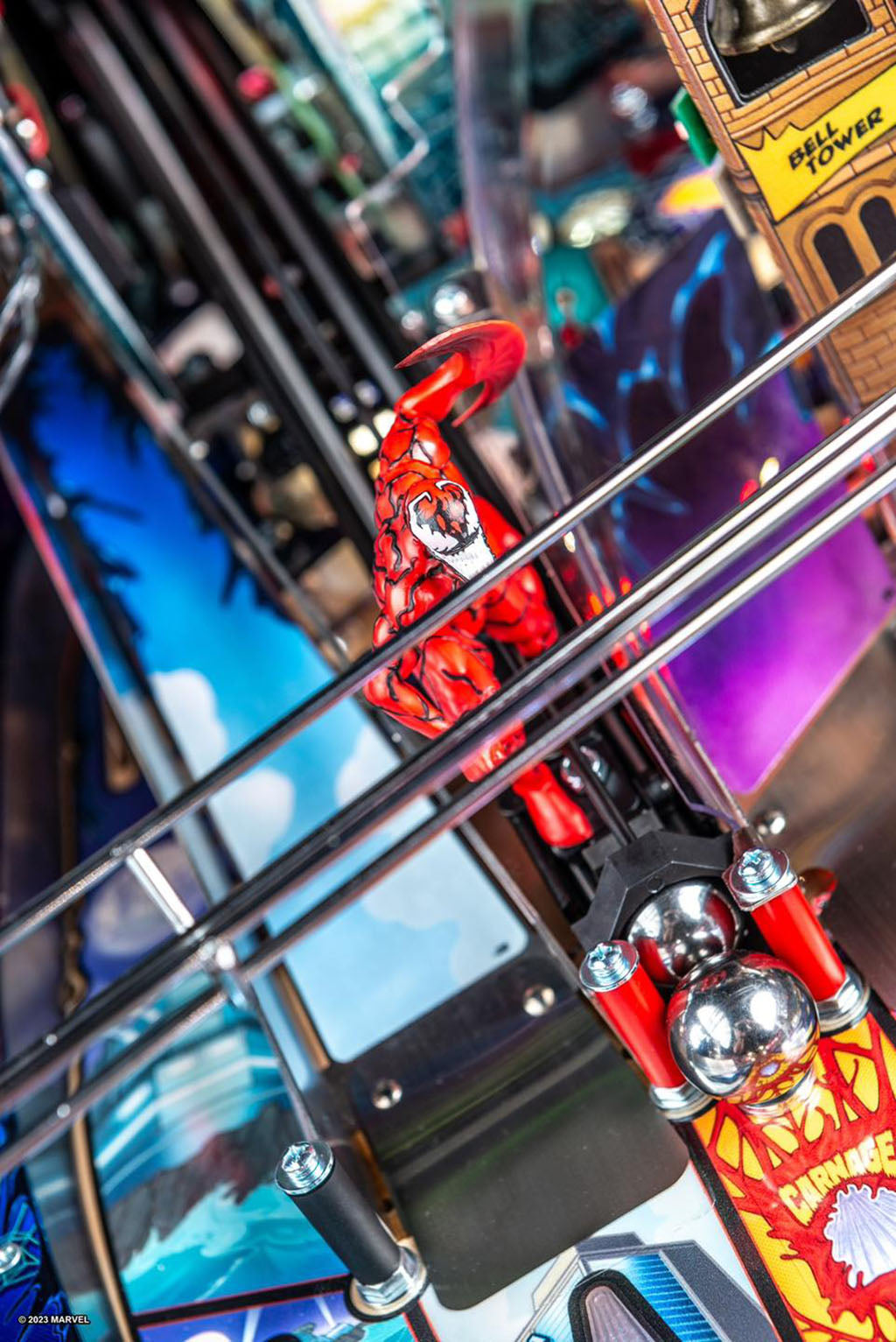 Colorful toy figure on a metallic surface with blurred background