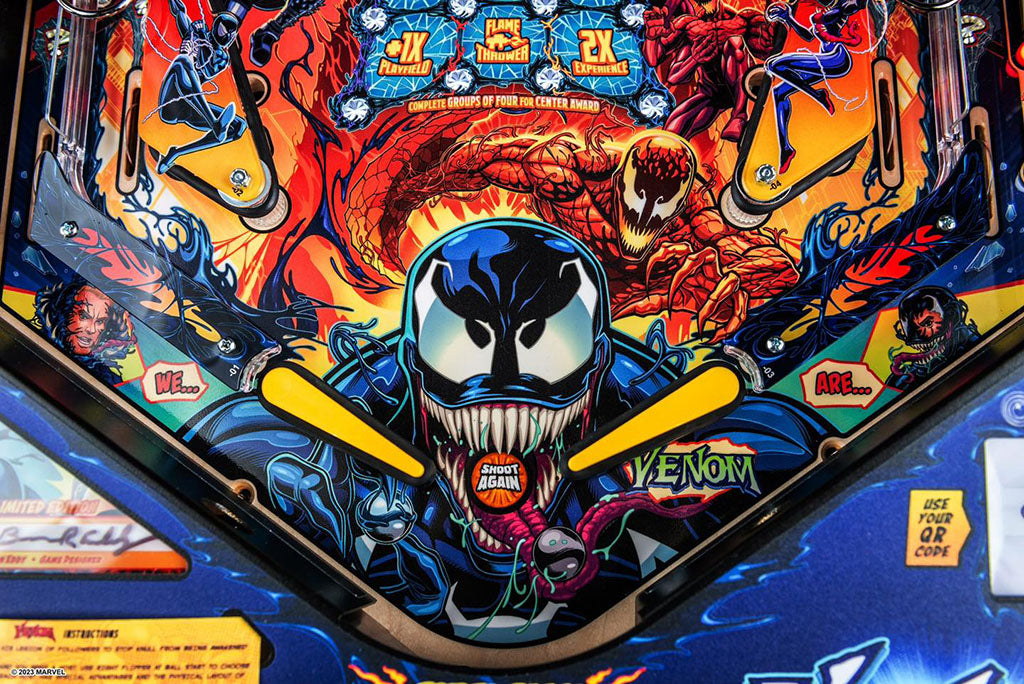 Pinball machine with Venom artwork featuring the character's face and name.
