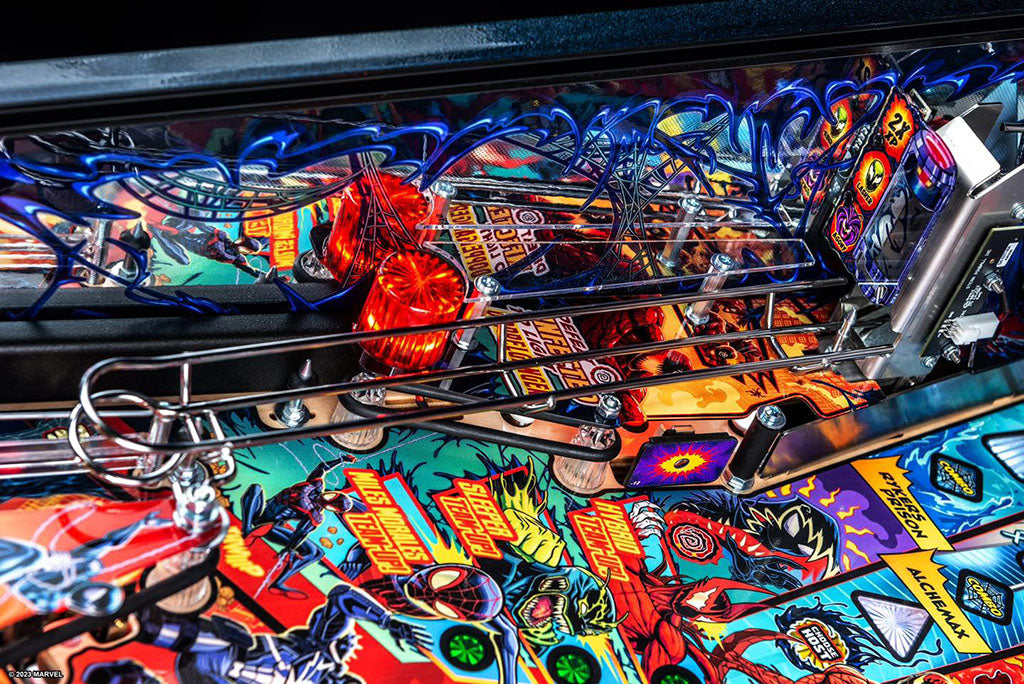 Close-up of a colorful pinball machine with intricate details and vibrant graphics.