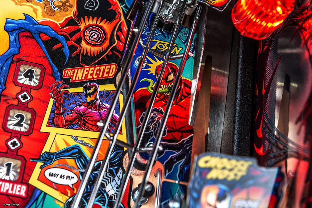 Close-up of a pinball machine with colourful artwork and player number display.