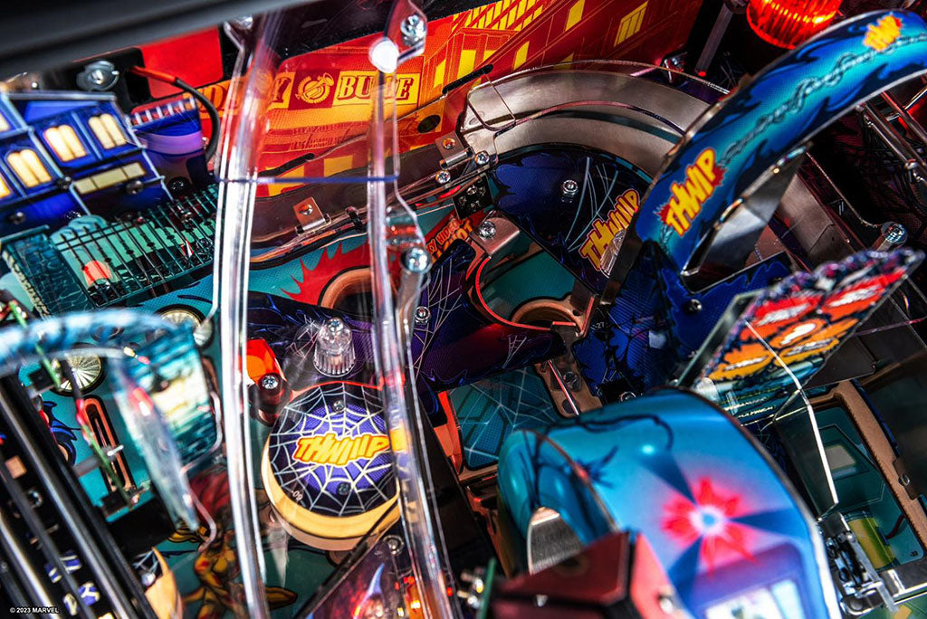 Close-up of a colorful pinball machine with various lights and components.