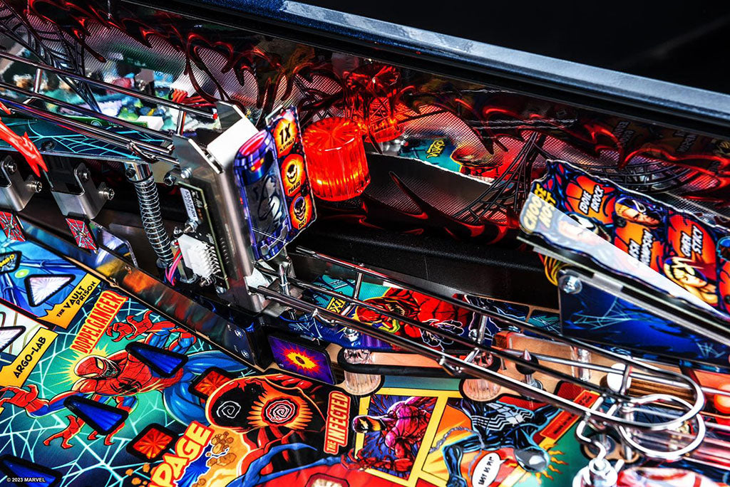 Close-up of a colorful pinball machine with various characters and graphics.