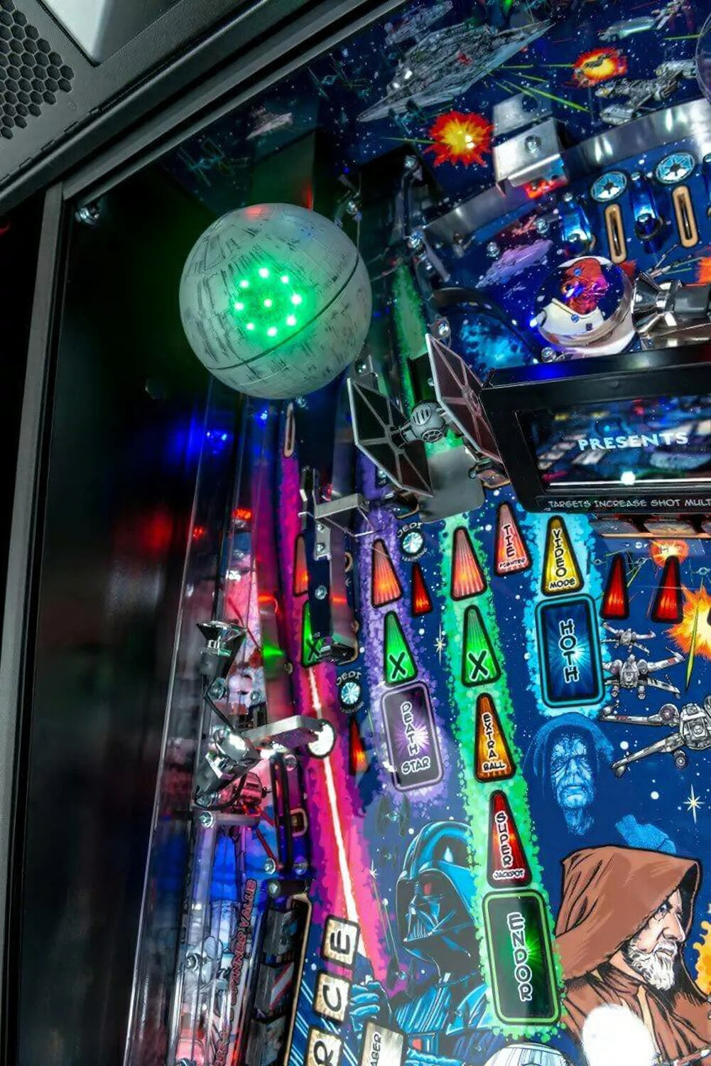 Close-up of a pinball machine with colourful Star Wars theme and vibrant graphics.