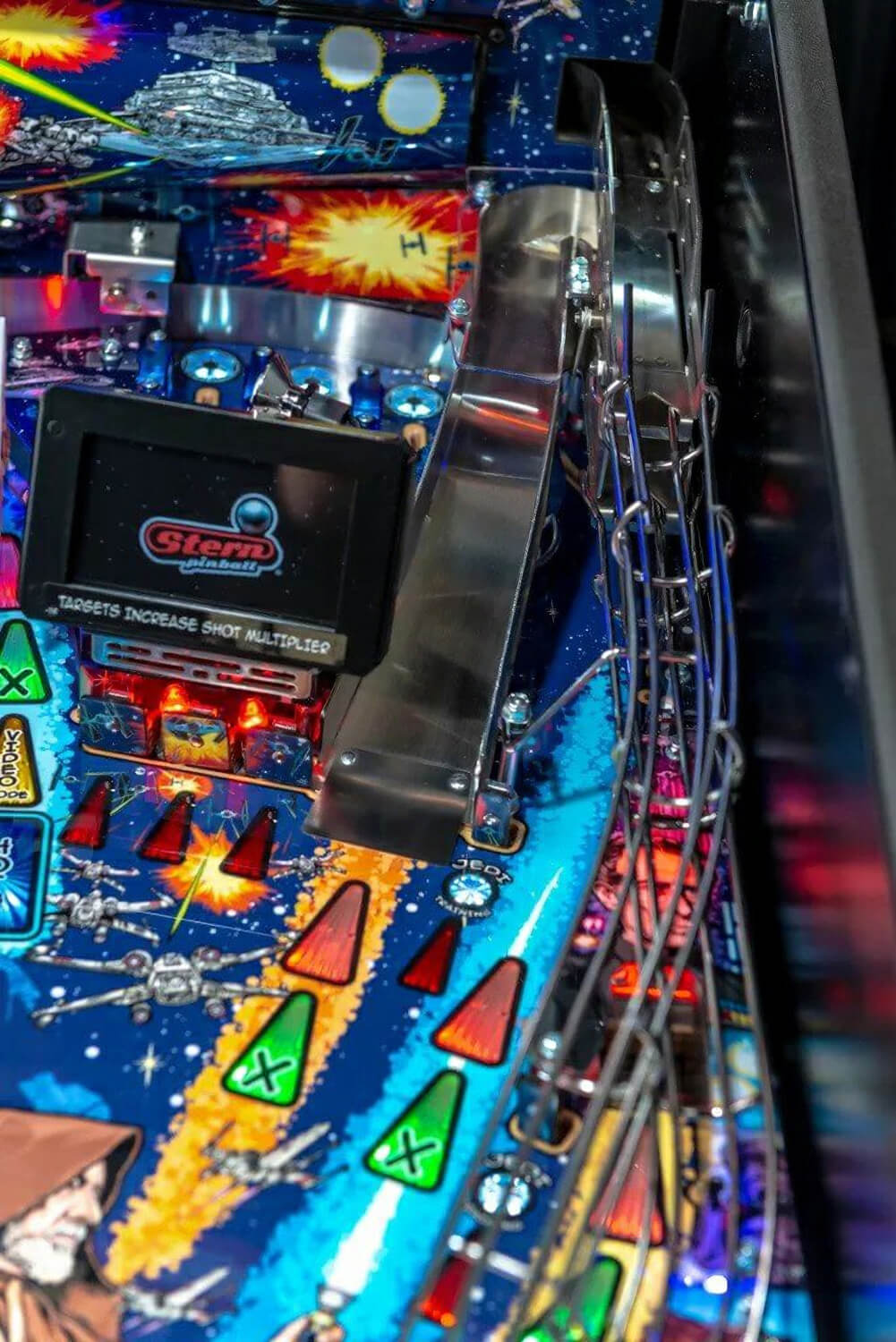 Close-up of a pinball machine with colourful artwork and Stern branding.