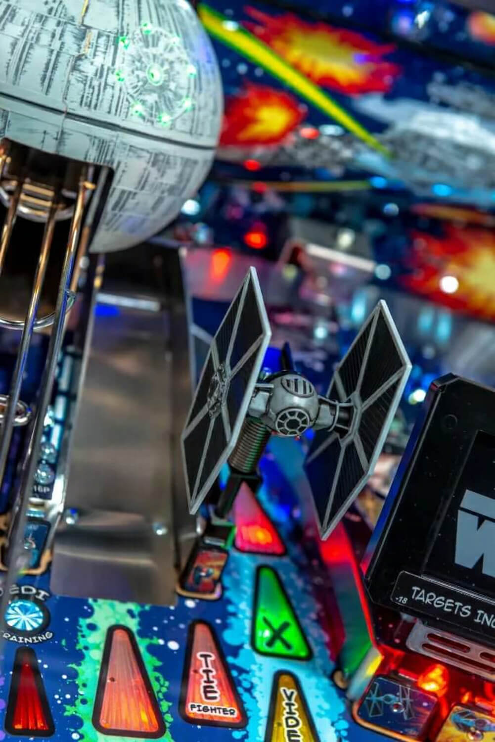Pinball machine with Star Wars-themed playfield featuring a TIE fighter figure and Death Star.