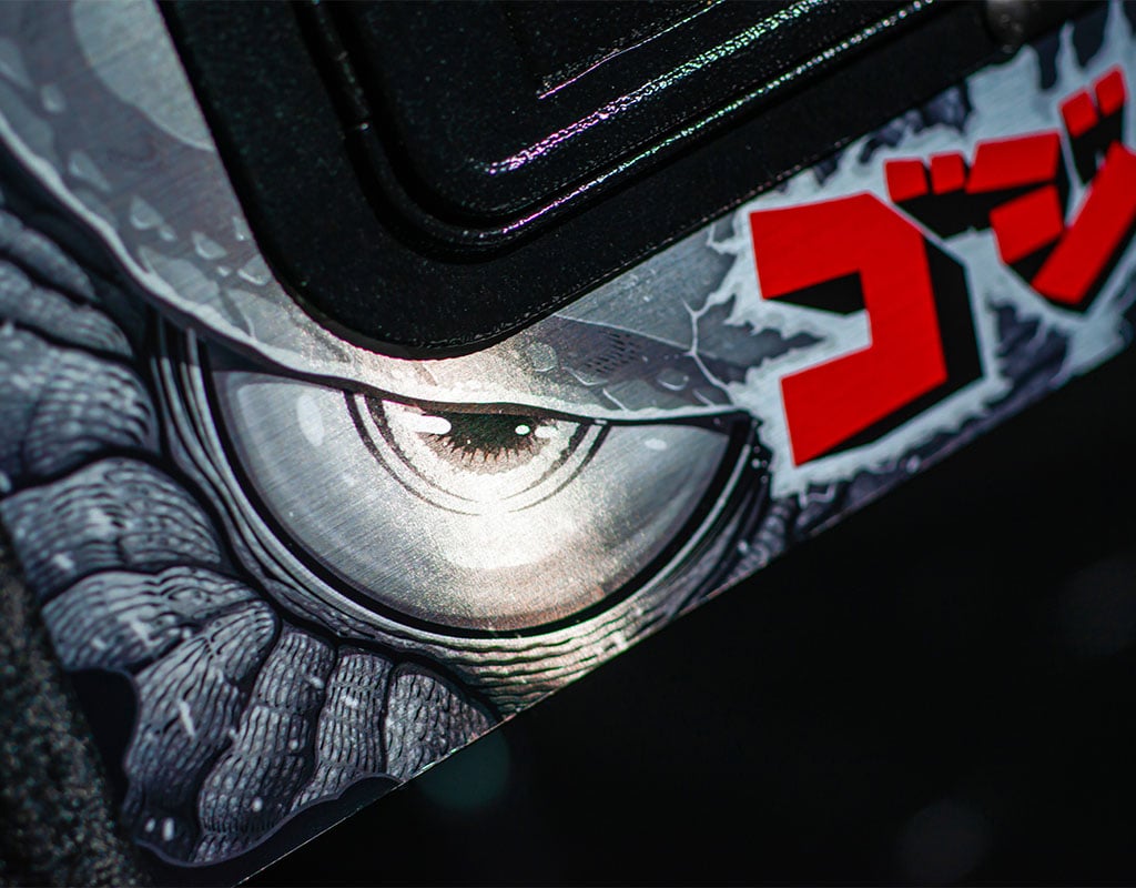 Close-up of a character with a large eye and Japanese text on a dark background
