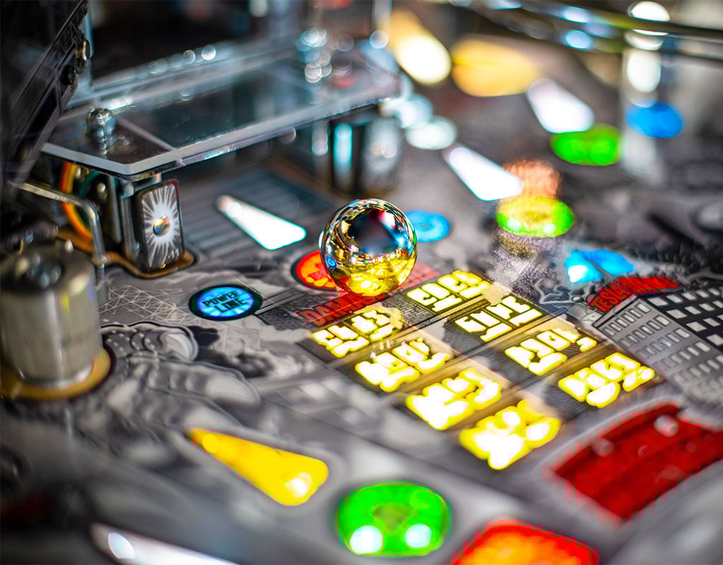 Close-up of a pinball machine with colorful components. 