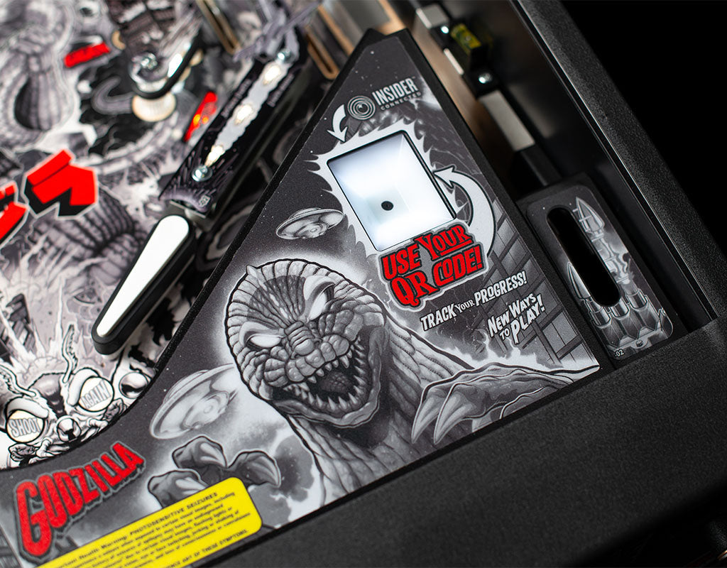 Pinball machine with Godzilla artwork and 'Use Your QR Code' text