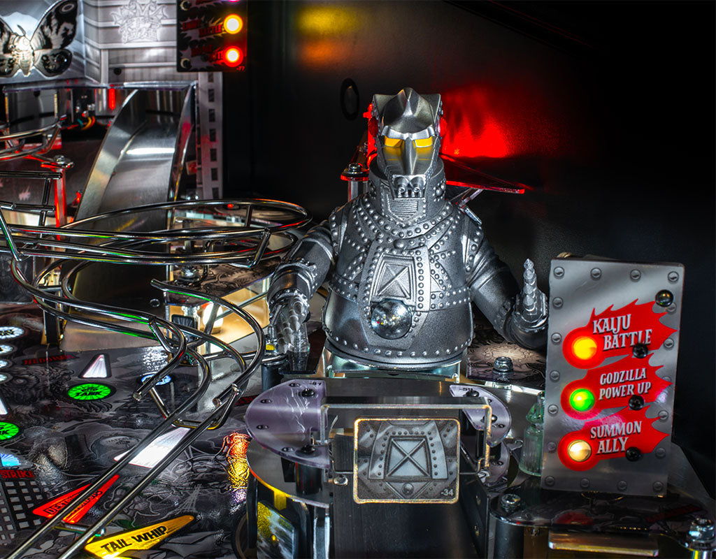 Metallic robot figure on a pinball machine with control panel