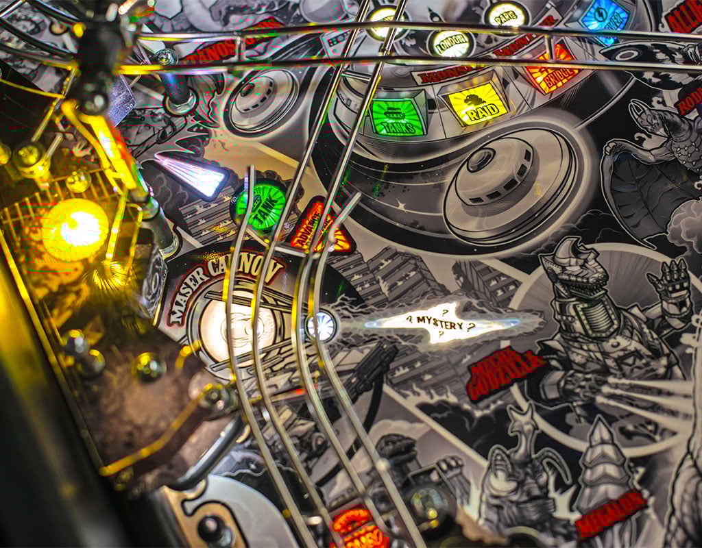 Close-up of a vintage pinball machine with colorful lights and detailed artwork.