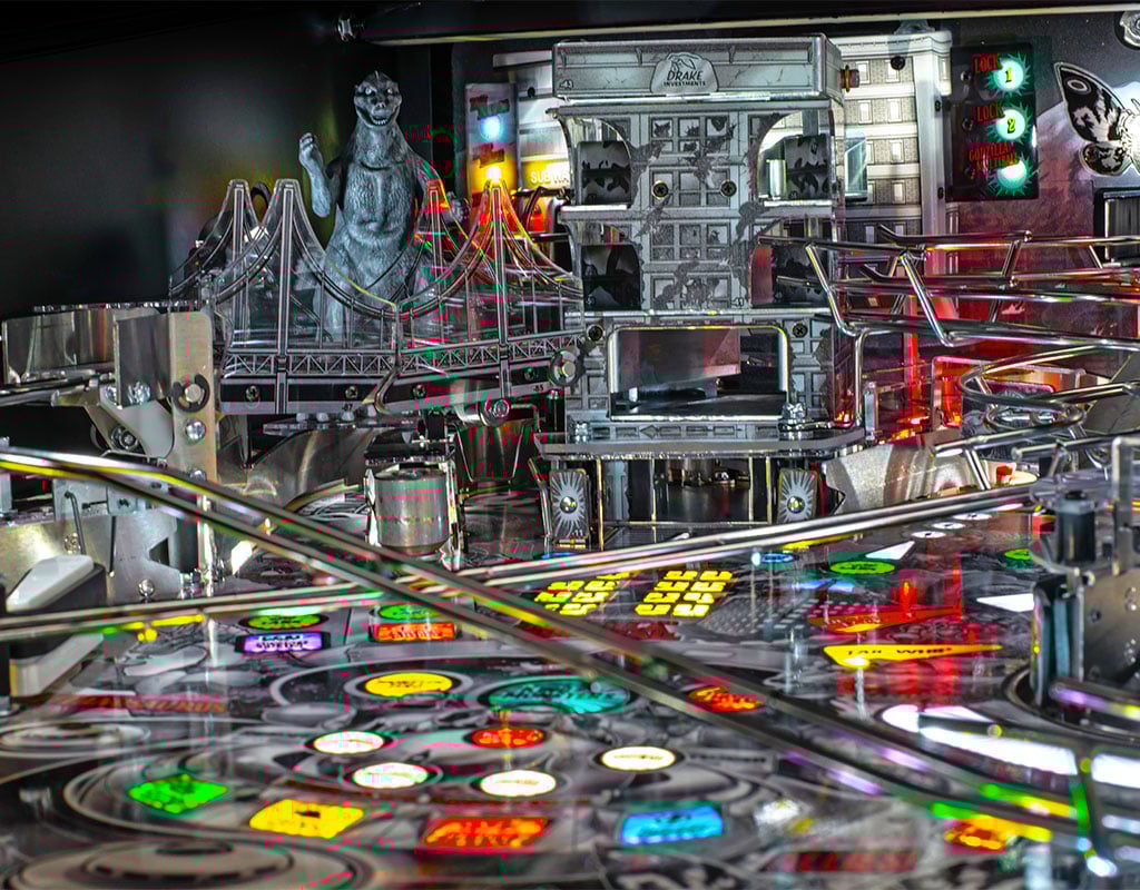 Close-up of a pinball machine with detailed playfield and vintage design.