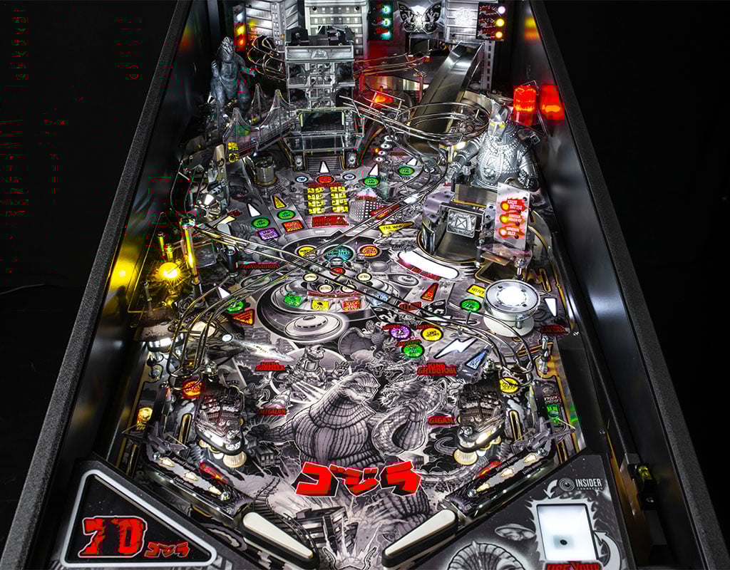 Pinball machine with detailed design and colorful lights on a black background