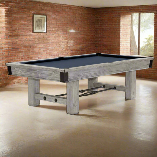A rustic grey Brunswick Canton American pool table with drop pockets.