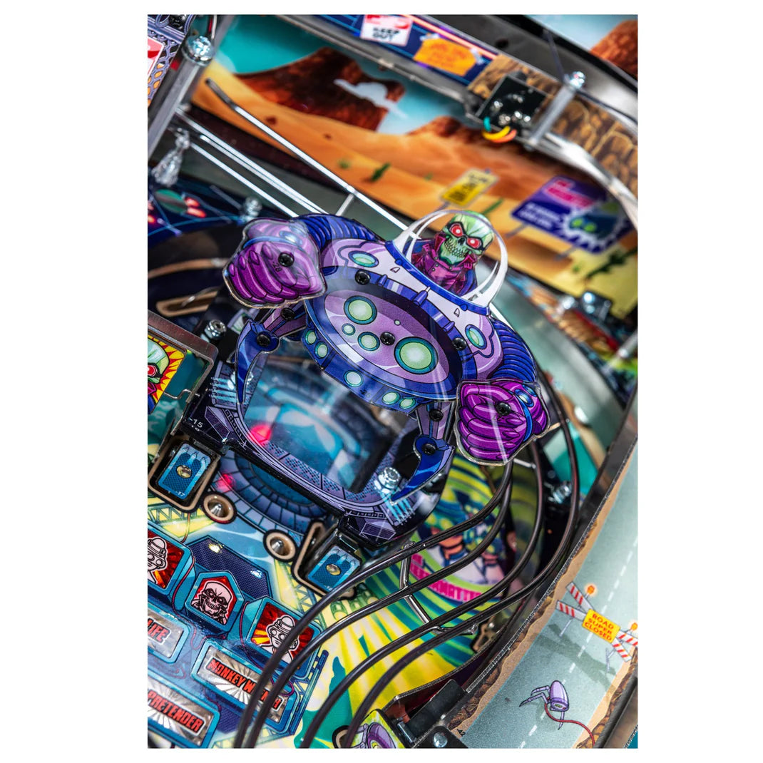 Close-up of a colorful pinball machine with a purple and blue turtle figure.