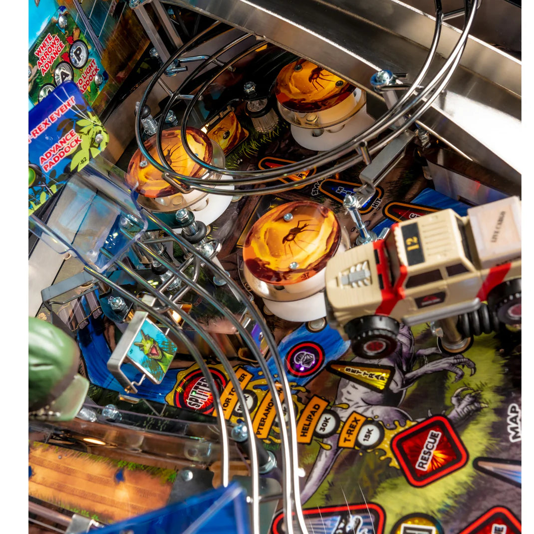 Close-up of a pinball machine with various components and players.