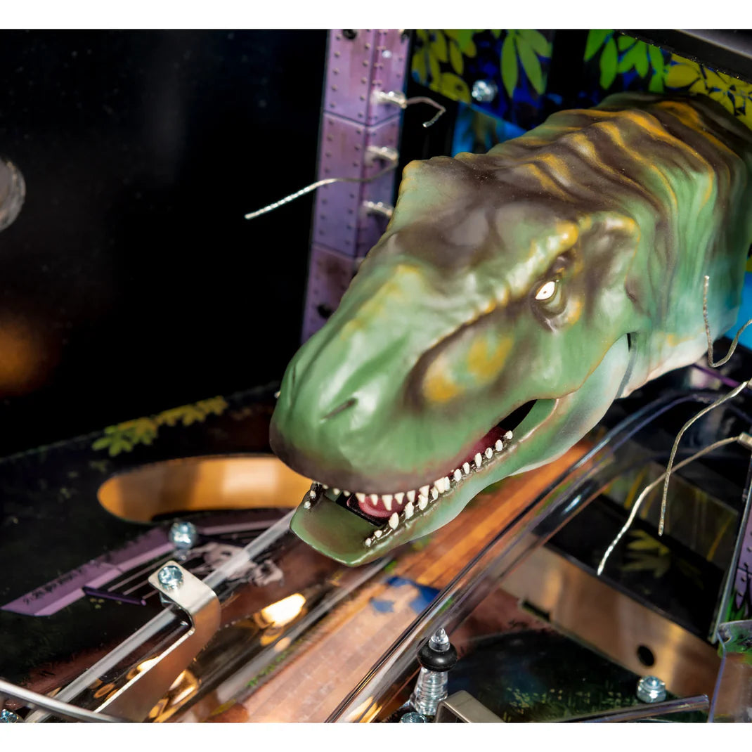 Dinosaur head figure on a pinball machine